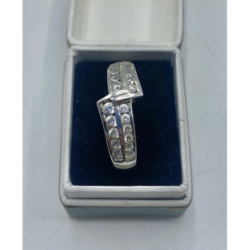 103 - An 18ct white gold and diamond half eternity ring. 3.6g. Size