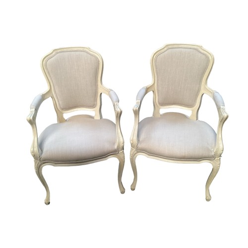 520 - A pair of French style upholstered open arm chairs