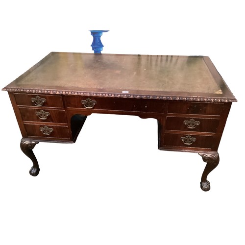 525 - Mahogany leather topped writing desk of nine drawers, two handles missing.  130 cm L x 77 cm H x 77 ... 