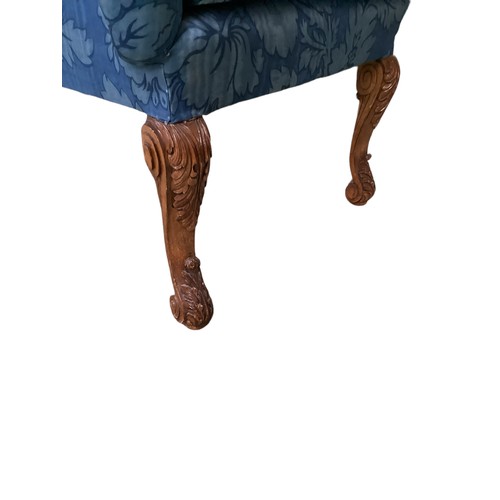 527 - Blue floral upholstered high backed arm chair on carved scrolling front legs.  119 cm H