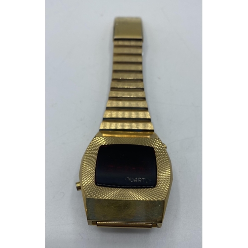 112 - A Quartus 2500 gilt metal digital watch. Red LED face with original bracelet strap. Numbered 2291.