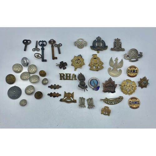 114 - A collection of military cap badges etc,