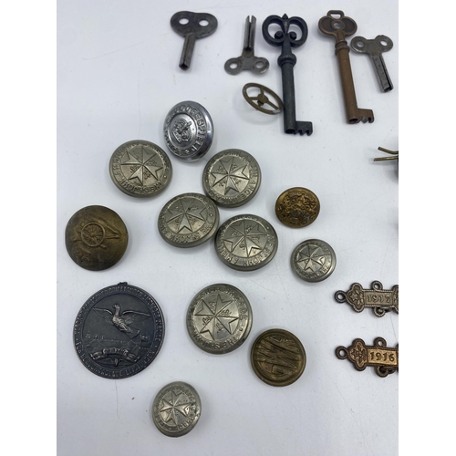 114 - A collection of military cap badges etc,