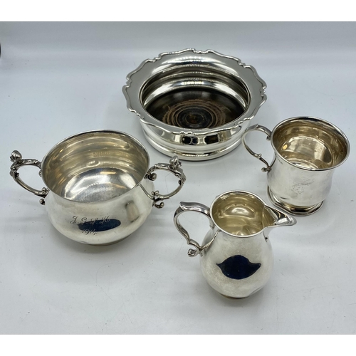 131 - A collection of sterling silver items to include a bottle coaster , cream jug, etc, Gross weight 706... 