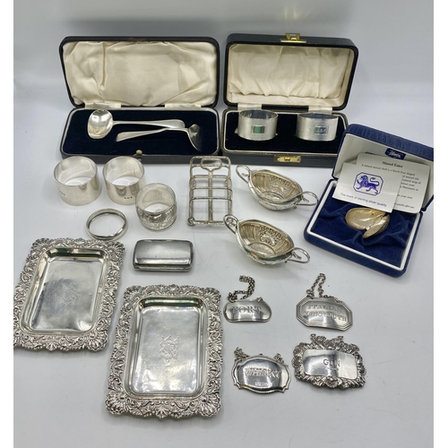 133 - A collection of sterling silver items together with a pair of Madras silver trays.