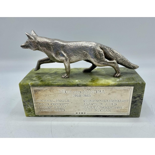 134 - An unmarked white metal fox mounted on green onyx plinth, with hallmarked silver plaque to front by ... 