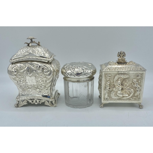 195 - A sterling silver tea caddy with repousse decoration by Carrington & Co London together with a a sim... 