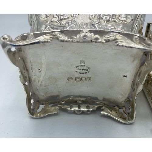 195 - A sterling silver tea caddy with repousse decoration by Carrington & Co London together with a a sim... 