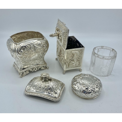 195 - A sterling silver tea caddy with repousse decoration by Carrington & Co London together with a a sim... 