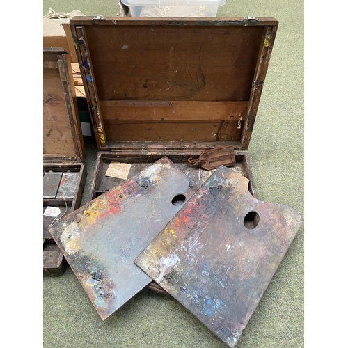 219 - A quantity of artist materials, including a wooden cased set with wooden easel and metal divisional ... 