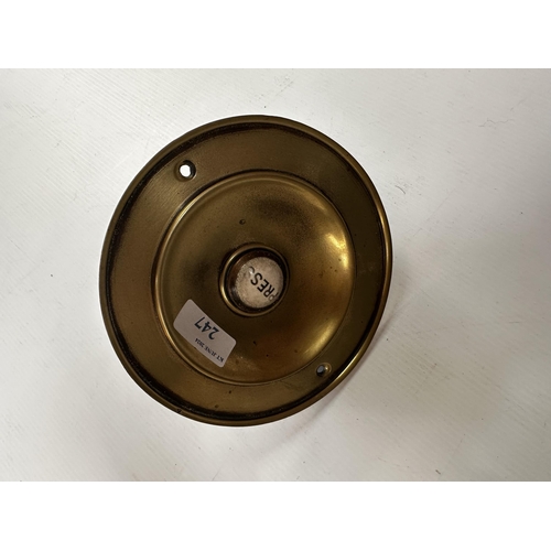 247 - An early 20th century brass bell push/doorbell. 15cm(d)