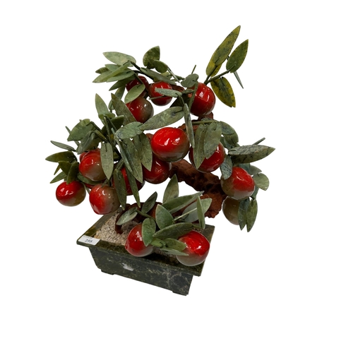 255 - A modern Chinese style hardstone decorative ornament of red fruit on tree, set in onxy style planter... 