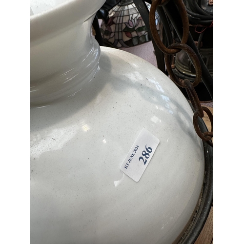 286 - A ceiling oil lamp with opaque white shaded and wrought iron mount. 70cm(h)