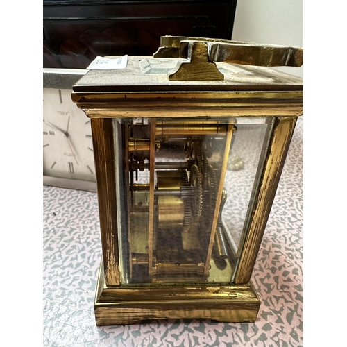 306 - A mahogany and brass cased mantle clock, the cream circular dial with black Roman Numerals marked W.... 