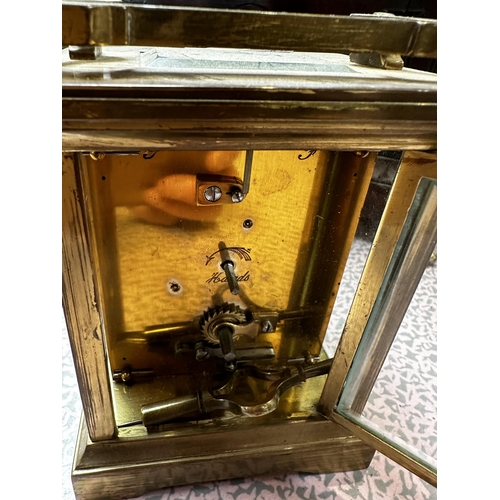 306 - A mahogany and brass cased mantle clock, the cream circular dial with black Roman Numerals marked W.... 