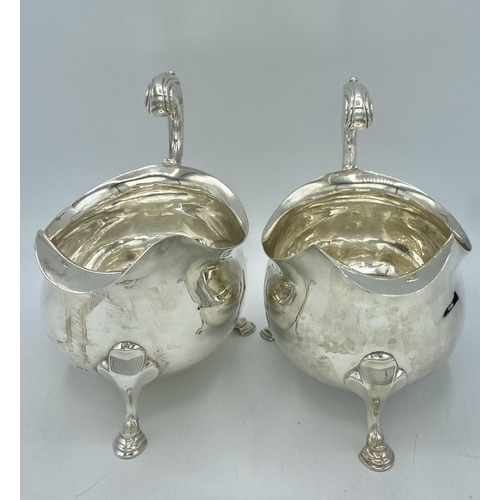 33 - A pair of large sterling silver sauce boats with scroll handles by Francis Crump London 1757. 640g.