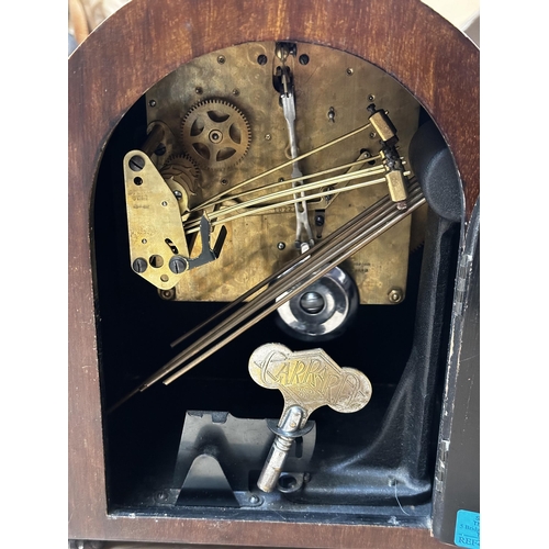 345 - An mahogany and brass mantle clock, the circular brass dial  stamped Rowell Oxford 28cm(h)