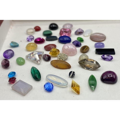 37 - A collection of gem stones and synthetic stones to include amethyst , moonstone, malachite, tigers e... 