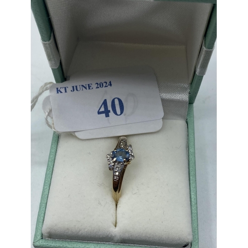 40 - A 9ct gold blue topaz and diamond ring. Size P. 2.61g