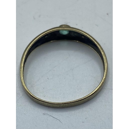 42 - An unmarked yellow metal emerald and diamond set band. Size n. 0.72g. ( Tested as 9ct)