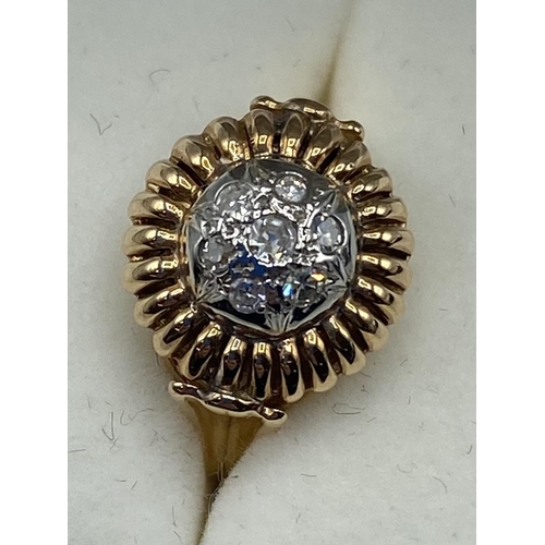 44 - An 18ct rose gold and diamond flower ring. Centrally set with seven single cut diamonds. Size M. 3.5... 