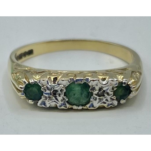 45 - A 9ct gold and white metal three stone emerald ring with single cut diamond accents. Size m. 2.08g.