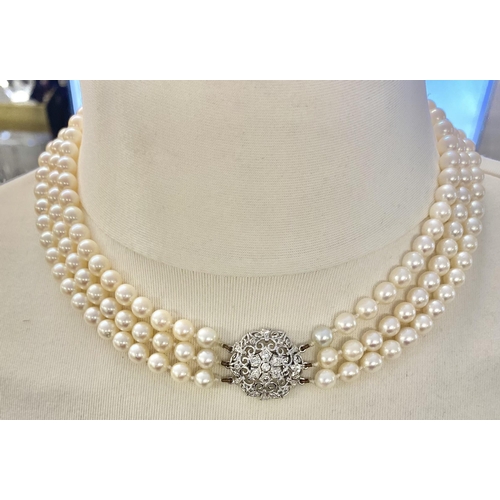 6 - A triple strand necklace of graduated pearls with unmarked 18ct white gold and diamond set clasp. Ap... 