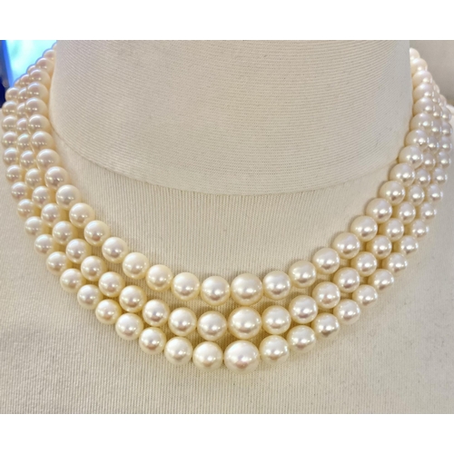 6 - A triple strand necklace of graduated pearls with unmarked 18ct white gold and diamond set clasp. Ap... 