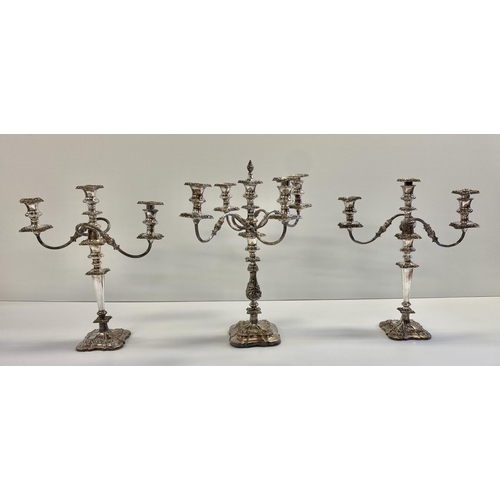 119 - Set of three silver plated table candelabra, central four branch with central holder with finial tog... 