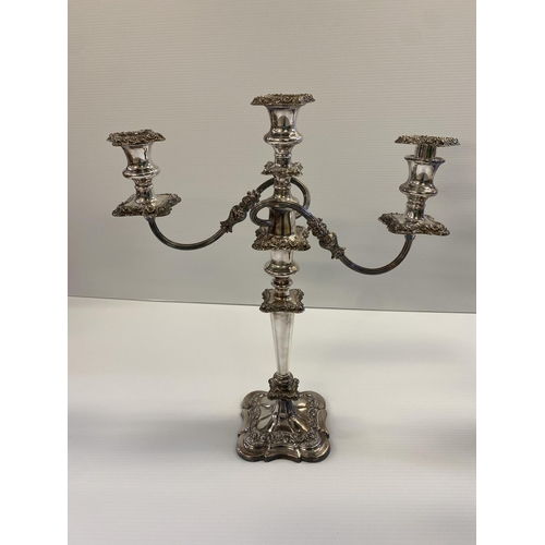 119 - Set of three silver plated table candelabra, central four branch with central holder with finial tog... 