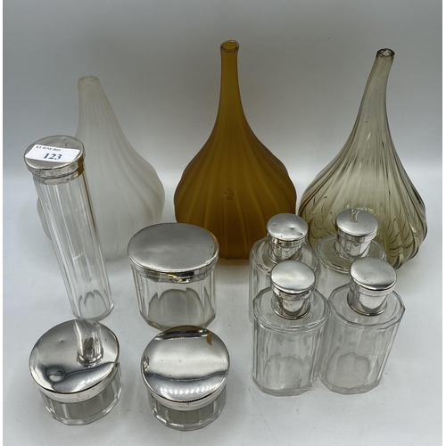 123 - A collection of white metal topped dressing table items together with three 20th century onion shape... 