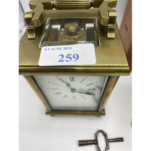 259 - Four gilt brass carriage clocks one with original fitted travel case.