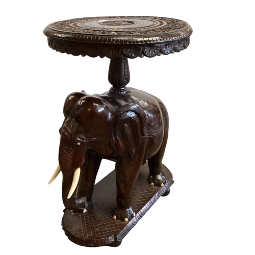 298 - Anglo Indian hardwood occasional table, with carved elephant base, 72cm High