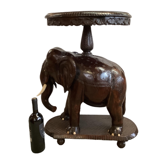 298 - Anglo Indian hardwood occasional table, with carved elephant base, 72cm High