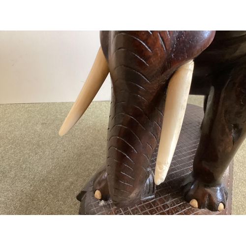 298 - Anglo Indian hardwood occasional table, with carved elephant base, 72cm High