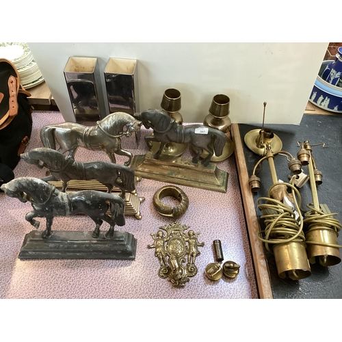 307 - A quantity of metal wares including horse shaped door stops, a slave bangle, brass candlesticks, wal... 