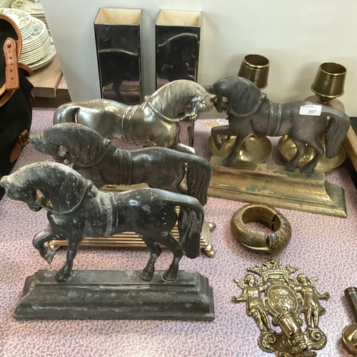 307 - A quantity of metal wares including horse shaped door stops, a slave bangle, brass candlesticks, wal... 