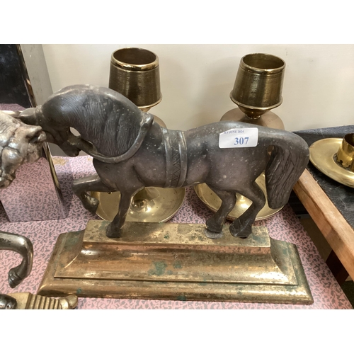 307 - A quantity of metal wares including horse shaped door stops, a slave bangle, brass candlesticks, wal... 