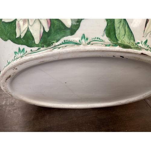 318 - A quantity of large china bowls and planters, etc to include  a large green and white two handled, a... 