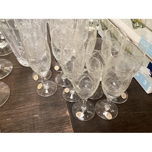 319 - A quantity of glass to include Uranium glass champagne flutes, wine glasses, tumblers  decanters etc... 