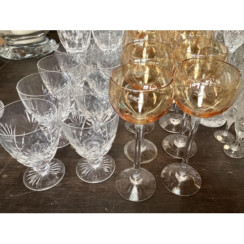 319 - A quantity of glass to include Uranium glass champagne flutes, wine glasses, tumblers  decanters etc... 