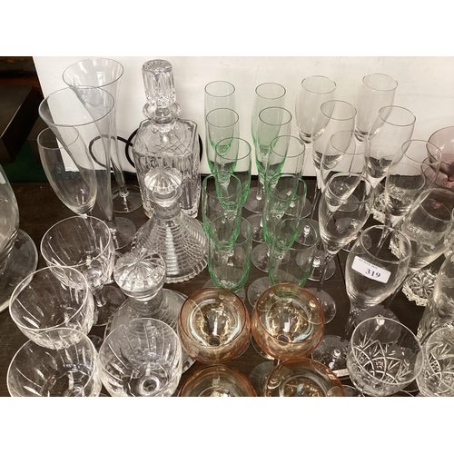 319 - A quantity of glass to include Uranium glass champagne flutes, wine glasses, tumblers  decanters etc... 