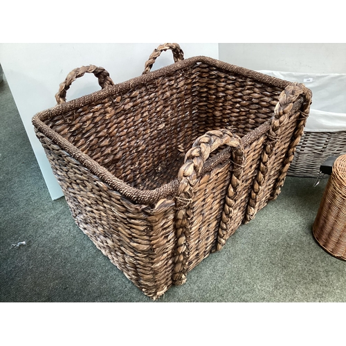 355 - A large modern OKA style basket, an oval basket, and two basket covered pedestal bins