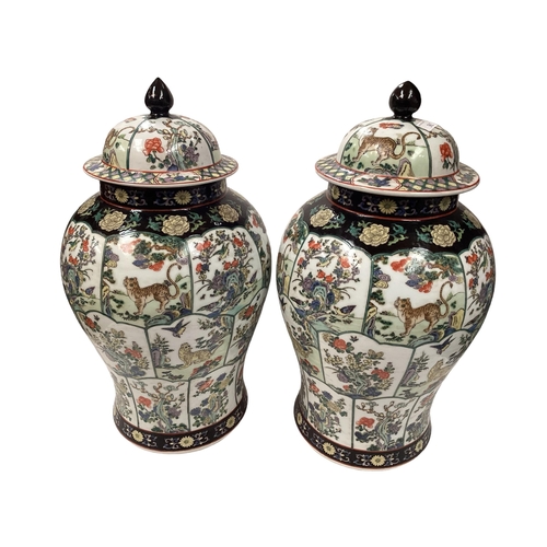 362 - A pair of Oriental style polychrome decorated lidded baluster vases with red seal mark to base, 61cm... 