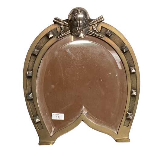 371 - Bronze and unmarked white metal mirror in the form of a horse shoe topped by jockey hat with bevelle... 