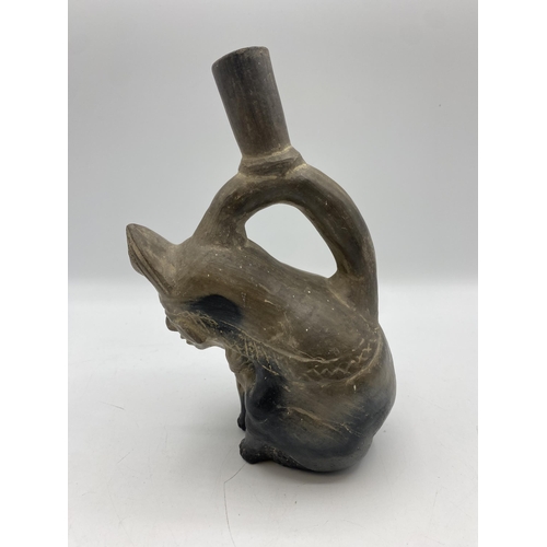 379 - A Moche stirrup spout figure vessel, Peru Terracotta of seated man with monkey. Circa 200BC. 21cm(h)