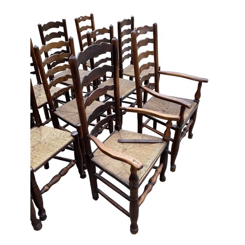 617 - A harlequin set of 12 elm ladder back dining chairs with rush seats.(12)