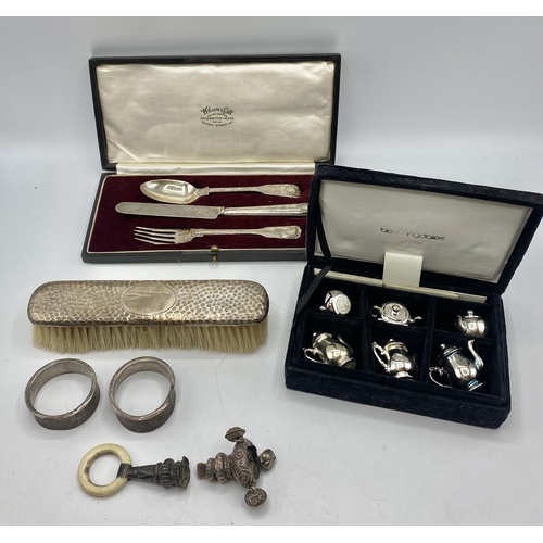193 - A small collection of sterling silver and white metal items . Christening set rattle etc.