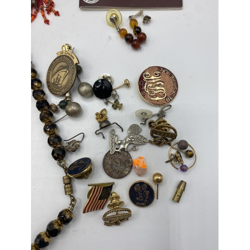 65 - A collection of costume and bead jewellery. A pair of amber drop ear rings. A jet style bead necklac... 