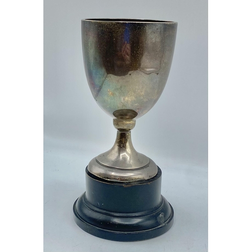 89 - A sterling silver chalice cup on turned wooden stand. by Walker and Hall Sheffield 1933. 15cm(h) 157... 